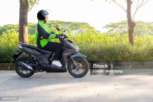 Asian Woman Works As A Motorcycle Taxi Driver On The Street